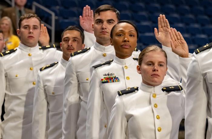 ROTC students hold up right hand to take an oath